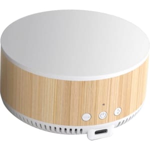 A round wireless charging speaker in a natural wood finish with a white top and control buttons on the front.