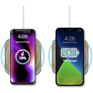 A wireless charger with a cork surface, featuring two smartphones displaying charging status indicators.