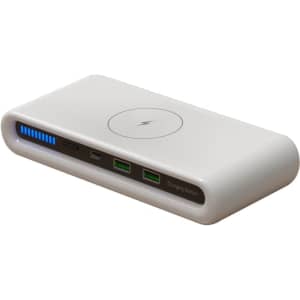 A white charging station featuring a wireless charging pad, USB ports, and an LED power indicator.