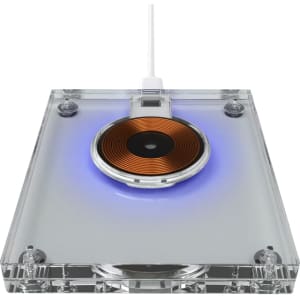 A clear acrylic wireless charger with a circular copper charging pad and blue ambient lighting.