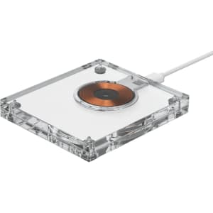 A 15-watt acrylic wireless charger in clear with a copper charging pad and a white cable.