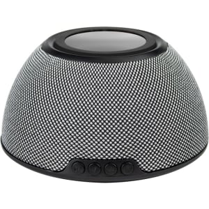 A black and silver wireless charging speaker with a textured surface and control buttons at the front, featuring a logo.