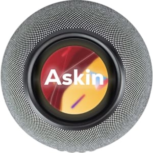 A round, grey wireless charging speaker with a central logo and a vibrant background design.