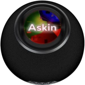 A black wireless charging speaker featuring a round design and a central logo.