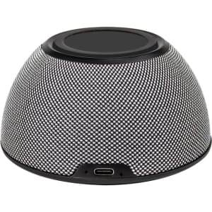A round, textured speaker in black and silver, featuring a wireless charging surface and a USB-C port.