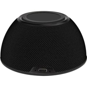 A black wireless charging speaker with a textured surface and a USB-C port at the base.