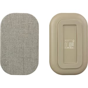 A beige wireless charger with a textured surface on one side and a smooth finish on the other, featuring a logo.