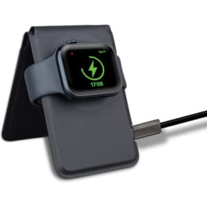 A grey magnetic card wallet and wireless charging stand with a smartwatch resting on it, connected by a charging cable.