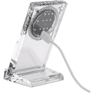 A transparent acrylic magnetic wireless charging stand with a white charging cable connected.