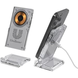 A clear acrylic wireless charging stand with a golden charging pad, designed for smartphones, featuring a logo.
