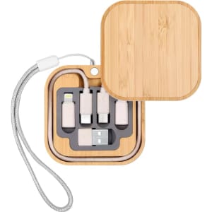 A bamboo case containing various charging cables and a wireless charger, with a silver strap.