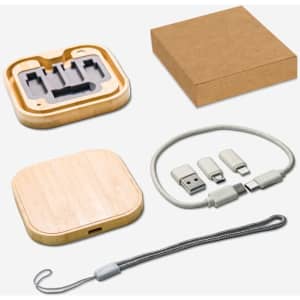 A bamboo wireless charger and a cable kit in a kraft box, featuring grey and silver connectors and a grey strap.