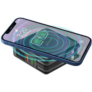 A black magnetic travel charger with a smartphone on top, displaying a wireless charging graphic.