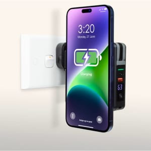 A magnetic travel charger in black with a charging smartphone displayed above, designed for convenience and portability.