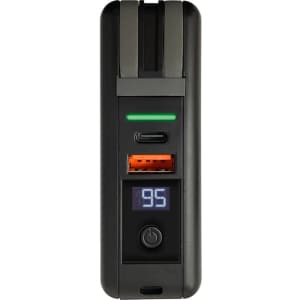 A black and green power bank with USB ports, digital display, and a logo.