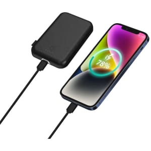 A black power bank connected to a smartphone displaying a battery charge level on the screen.