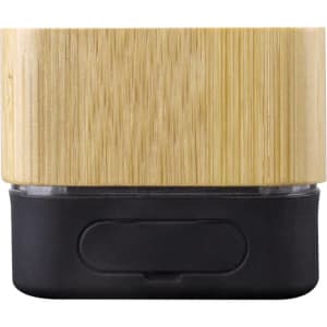 A bamboo wireless speaker features a natural bamboo exterior and a black base, with a minimalist design and a logo.