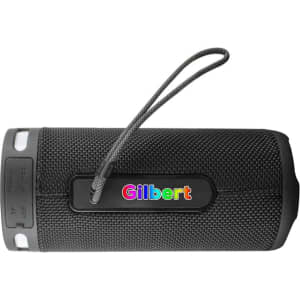 A black wireless speaker with a textured surface and a carrying strap, featuring a branding logo.