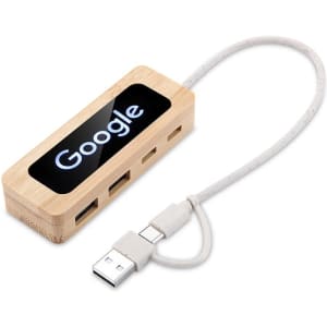 A bamboo USB hub with a white cable, featuring a logo on a black surface.