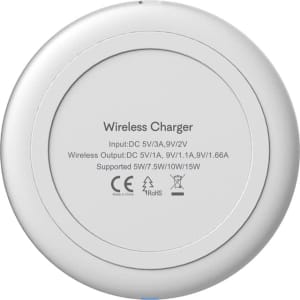 A round, white wireless charger with a smooth surface and a logo on the underside.