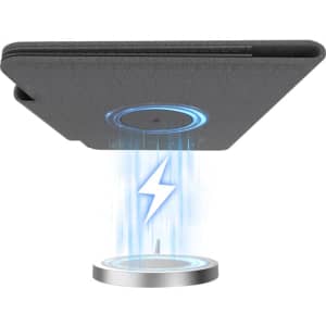 A grey passport holder features a wireless charging base with a blue light and a logo emblem.