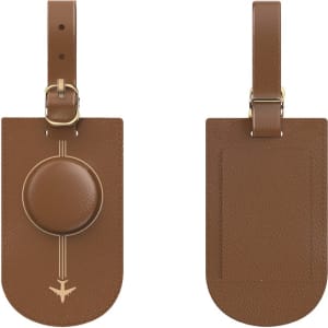 A brown luggage tag with a smooth circular attachment, featuring a subtle design and a loop for securing to luggage.