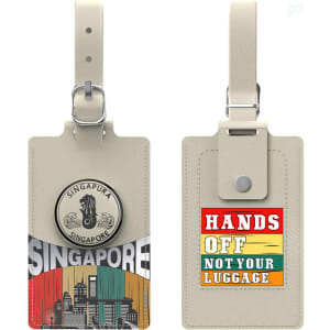 A beige luggage tag featuring a cityscape design of Singapore and a coloured message on the reverse side.