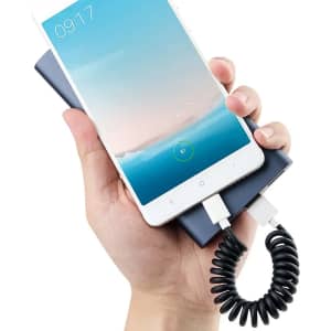 A Type-C charge cable kit in black, connecting a smartphone to a power bank in a hand.