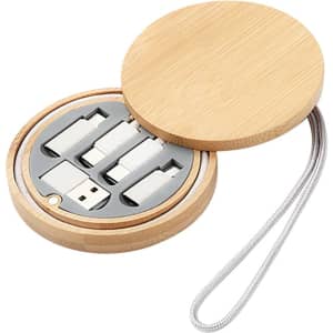 A compact bamboo kit featuring charging cables in a round case with a grey interior and a loop for easy carrying.