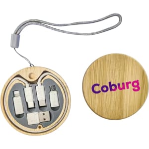 A round bamboo case containing a multi-cable charging kit with various connectors, featuring a logo.
