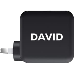 A black 100 Watt GaN quick charger with a plug and a branding logo on the side.
