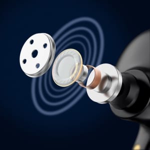 An exploded view of a black earbud component showcasing its internal structure, featuring a silver grill and circular diaphragm.