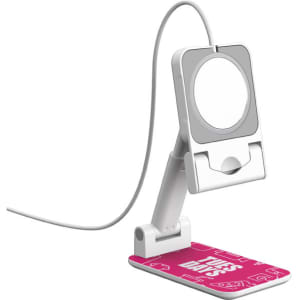 A white foldable phone stand with a pink base featuring a design and a circular holder for the device.