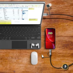 A fast charge and data sync LED cable connects a smartphone to a laptop, with earphones and a mouse nearby.