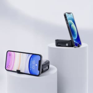 A mobile phone stand in black, holding a smartphone, displayed on white pedestals against a light background.
