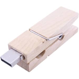 A wooden peg flash drive with a USB connector, showcasing a natural wood finish. It features a logo on the surface.