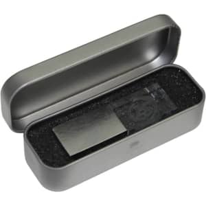 A 3D crystal flash drive in a grey metal case, resting on black foam padding. The case is open.