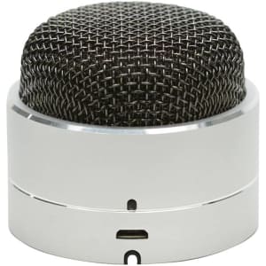 A compact silver Bluetooth speaker with a black mesh top and a USB charging port at the base.