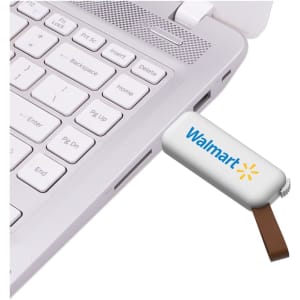 A white flash drive with a brown connector plugged into a laptop, featuring a logo on the drive.