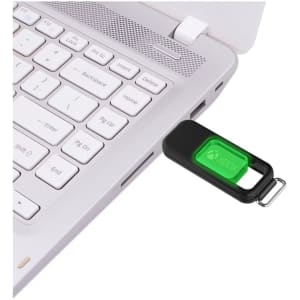 A flash drive in black and green connected to a laptop's USB port, featuring a logo.