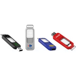 A collection of four flash drives in black, grey, blue, and red, each featuring a logo and distinct designs.
