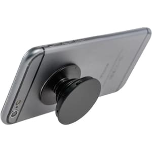 A black phone stand attached to the back of a silver smartphone. The stand has a circular shape.