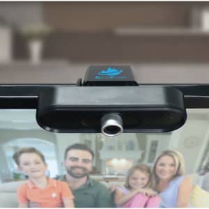 A black webcam camera featuring a silver lens, mounted on a monitor, with a logo visible on top.