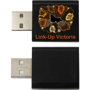 A black USB data blocker with a decorative logo on the front, featuring various designs and colours.