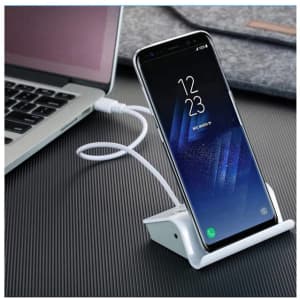 A white Media Hub Stand with a smartphone propped up, connected to a laptop via a USB cable.