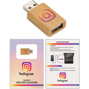 A bamboo USB data blocker with a USB plug, featuring a logo. Accompanied by instructional cards.