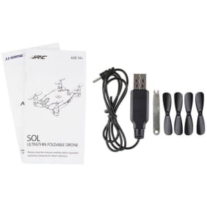 A foldable drone in black with a USB charging cable, extra propellers, and a user manual.