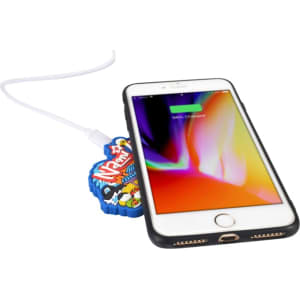 A custom moulded wireless charger in vibrant colours, with a smartphone partially on it, connected by a charging cable.