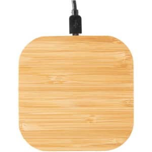 A square bamboo wireless charger with a black cable attached, featuring a smooth wooden texture.
