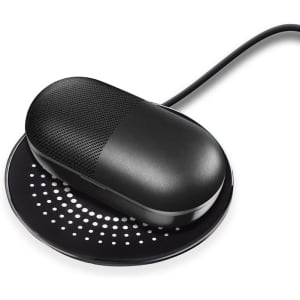 A black wireless charger with a textured surface, featuring a rounded design and a cable connector.